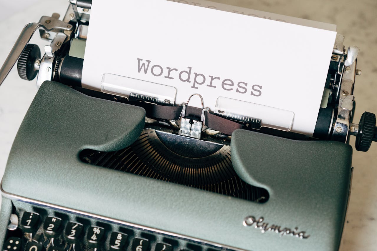Close-up of a vintage typewriter with a paper displaying WordPress in retro style.